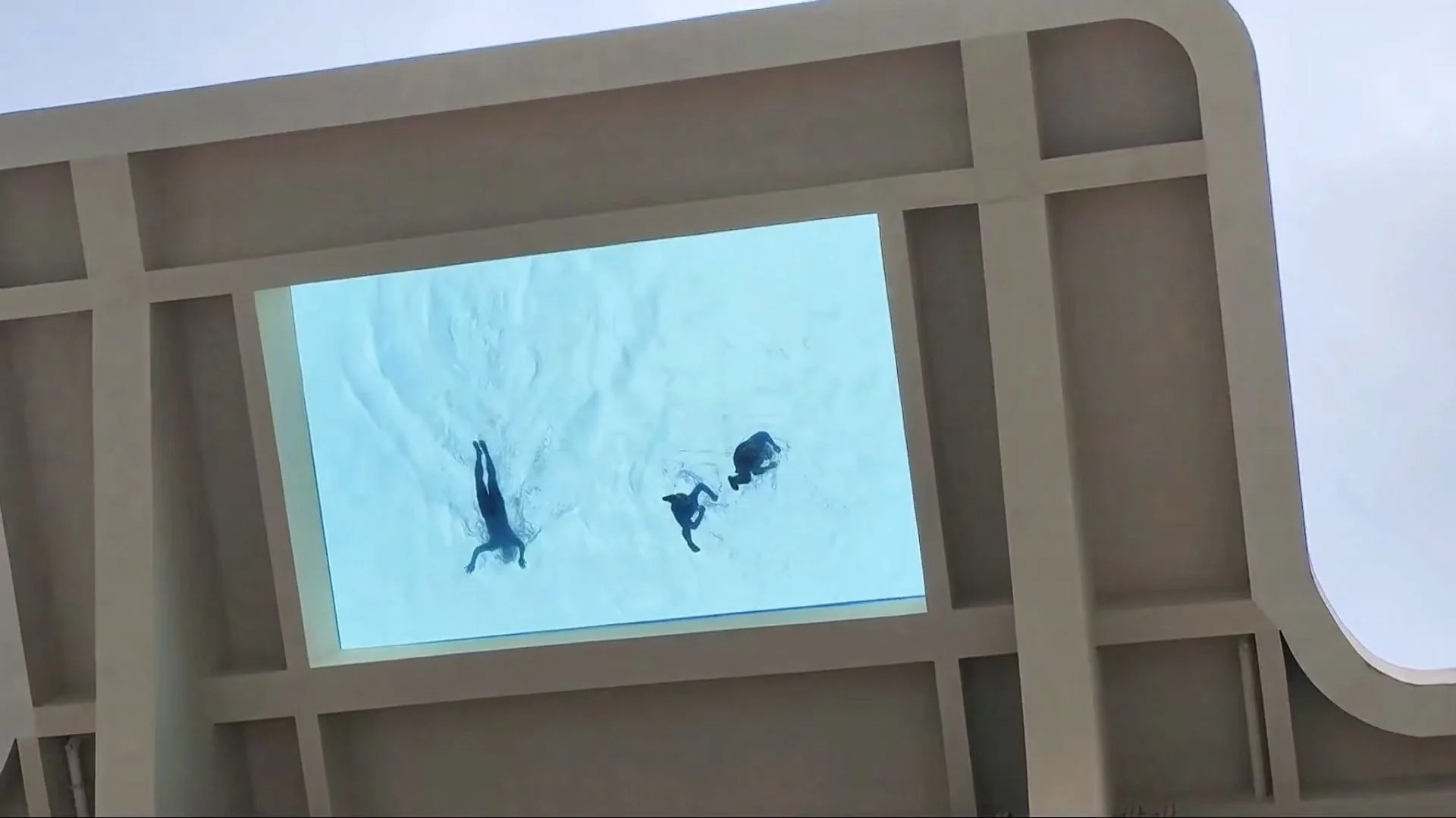 Closer view of the transparent pool floor from below.